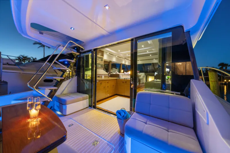 Slide: The Image of Luxurious 2015 Tiara Yachts interior with elegant seating and ambient lighting at sunset. - 15