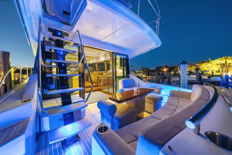 Slide: The Image of Luxurious 2015 Tiara Yachts interior with elegant seating and ambient lighting at night. - 16