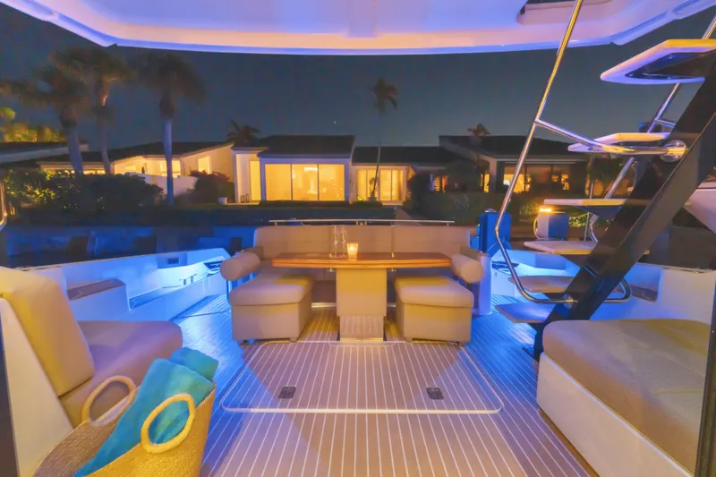 Slide: The Image of Luxurious 2015 Tiara Yachts deck at night, featuring elegant seating and ambient lighting. - 17