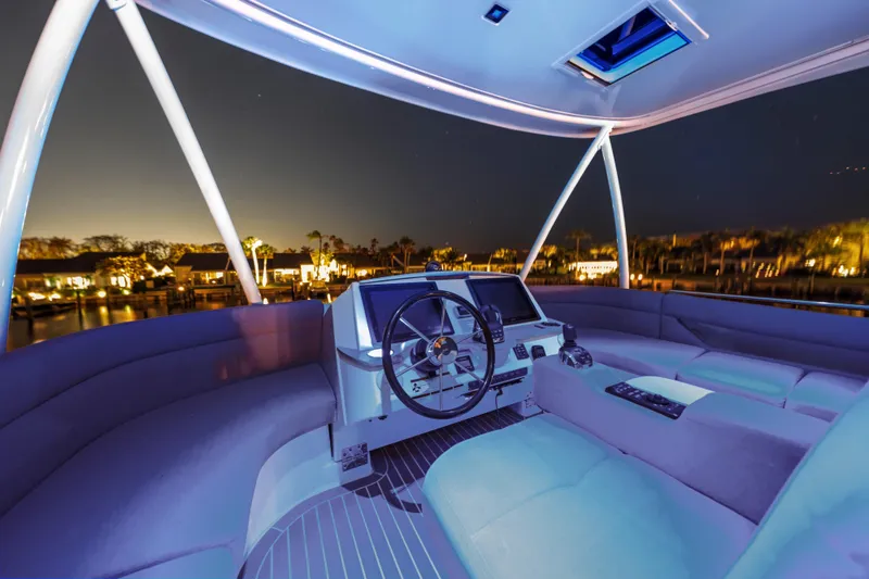 Slide: The Image of Luxurious 2015 Tiara Yachts cockpit at night with ambient lighting and waterfront view. - 18