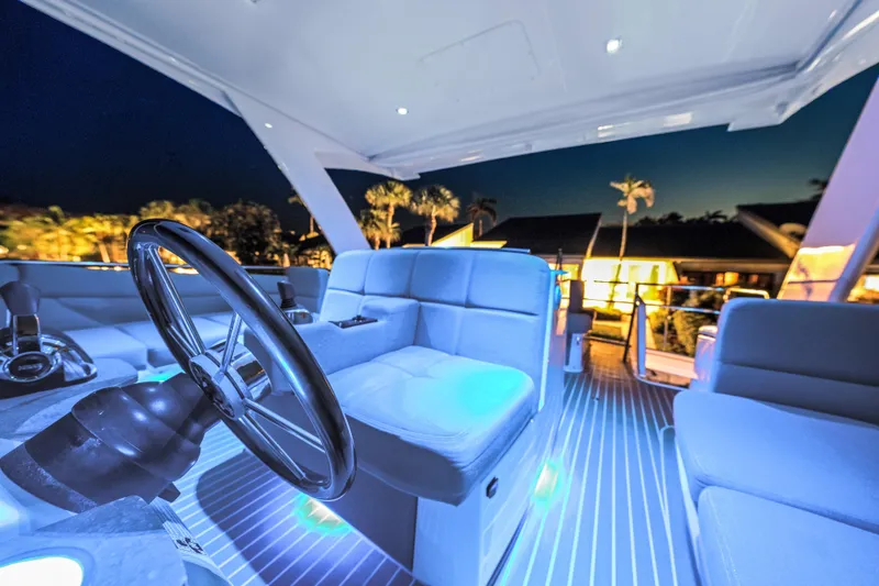 Slide: The Image of Luxurious 2015 Tiara Yachts interior with illuminated seating and steering wheel at night. - 19