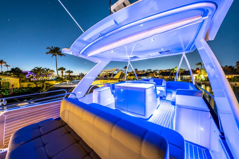 Slide: The Image of Luxurious 2015 Tiara Yachts deck illuminated at night, featuring modern seating and ambient lighting. - 20