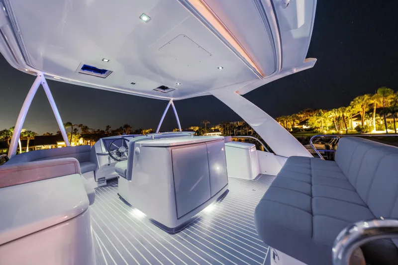 Slide: The Image of Luxurious 2015 Tiara Yachts deck at night, featuring elegant seating and ambient lighting. - 21