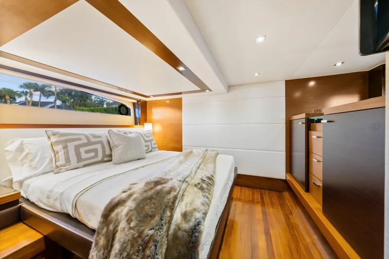 Slide: The Image of Luxurious 2015 Tiara Yachts bedroom interior with elegant bedding and wooden accents. - 33