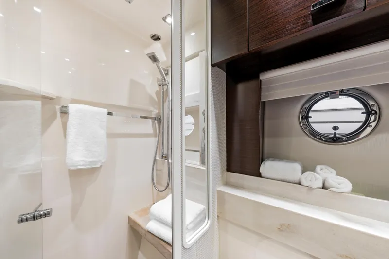 Slide: The Image of Luxurious 2015 Tiara Yachts bathroom with modern shower and porthole window. - 35