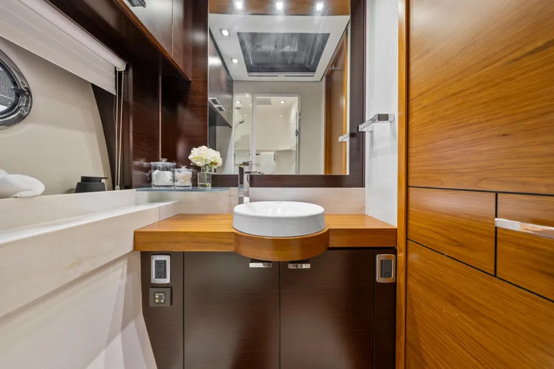 Slide: The Image of Luxurious 2015 Tiara Yachts bathroom with modern sink, wood accents, and elegant decor. - 36