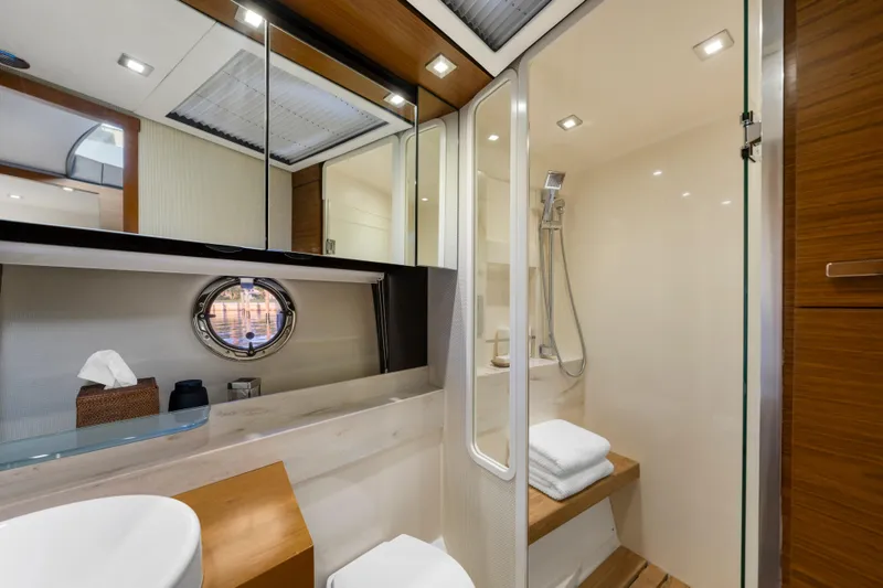 Slide: The Image of Luxurious 2015 Tiara Yachts bathroom with modern shower and elegant wood accents. - 39