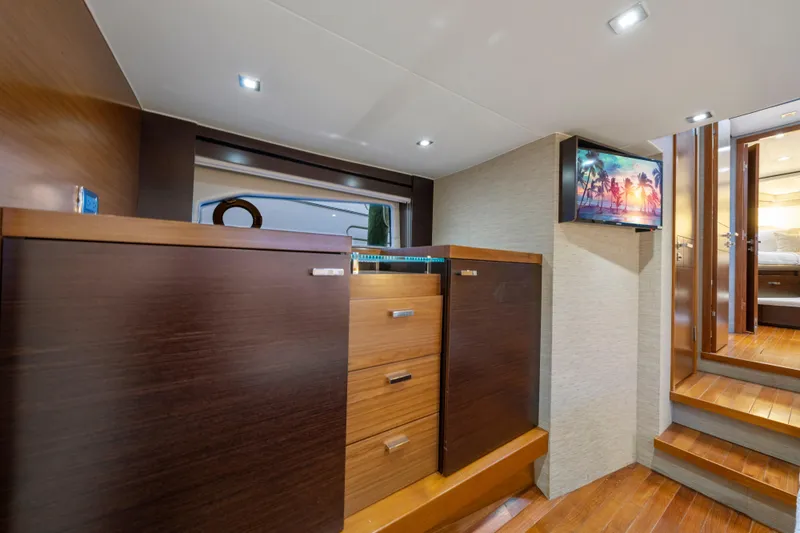 Slide: The Image of Luxurious 2015 Tiara Yachts interior with wooden cabinetry and mounted TV. - 42