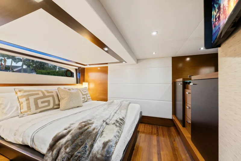Slide: The Image of Luxurious 2015 Tiara Yachts bedroom interior with elegant bedding and modern wood finishes. - 44