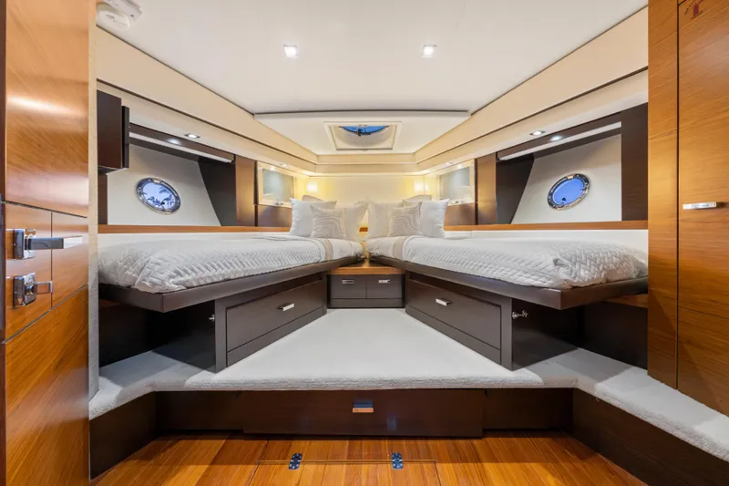 Slide: The Image of Luxurious 2015 Tiara Yachts cabin interior with twin beds and elegant wood finishes. - 46