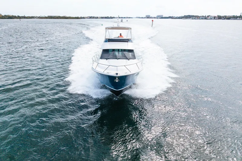 Slide: The Image of 2015 Tiara Yachts cruising on open water, creating a dynamic wake. - 8