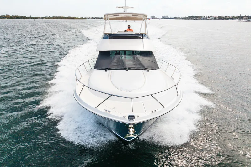 Slide: The Image of 2015 Tiara Yachts cruising on open water, front view with wake. - 9