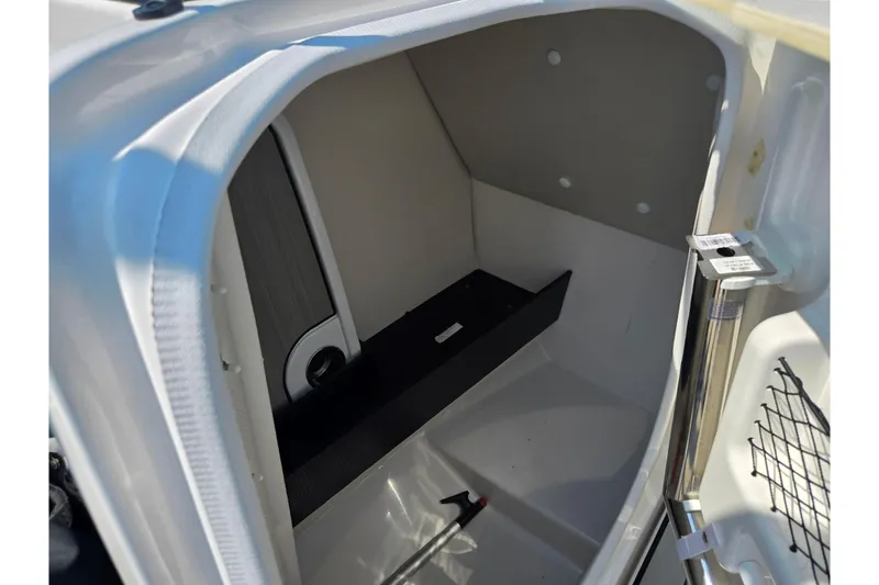 Slide: The Image of 2023 Yamaha Boats 252XE storage compartment interior, featuring sleek design and practical space. - 13