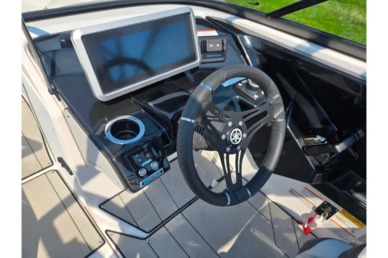 Slide: The Image of 2023 Yamaha Boats 252XE cockpit with steering wheel and touchscreen display. - 15