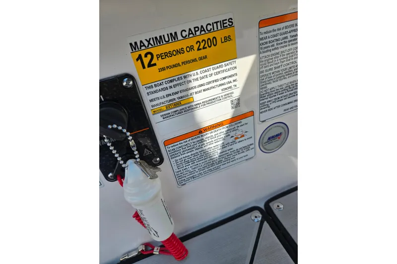 Slide: The Image of 2023 Yamaha Boats 252XE capacity label, maximum 12 persons or 2200 lbs, safety warnings visible. - 16