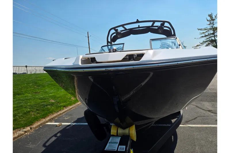 Slide: The Image of 2023 Yamaha Boats 252XE on trailer, sleek design, parked outdoors. - 6