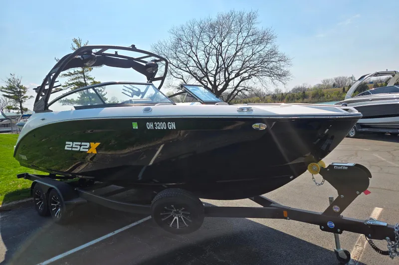 Slide: The Image of 2023 Yamaha Boats 252XE on trailer, parked outdoors, showcasing sleek design and modern features. - 8