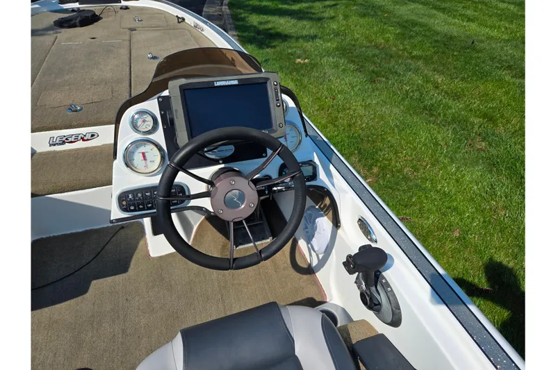 Slide: The Image of Cockpit of 2016 Legend Alpha 211R DC boat with steering wheel and control panel. - 12