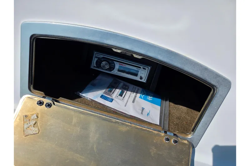 Slide: The Image of Storage compartment of 2016 Legend Alpha 211R DC with stereo system and manuals. - 13