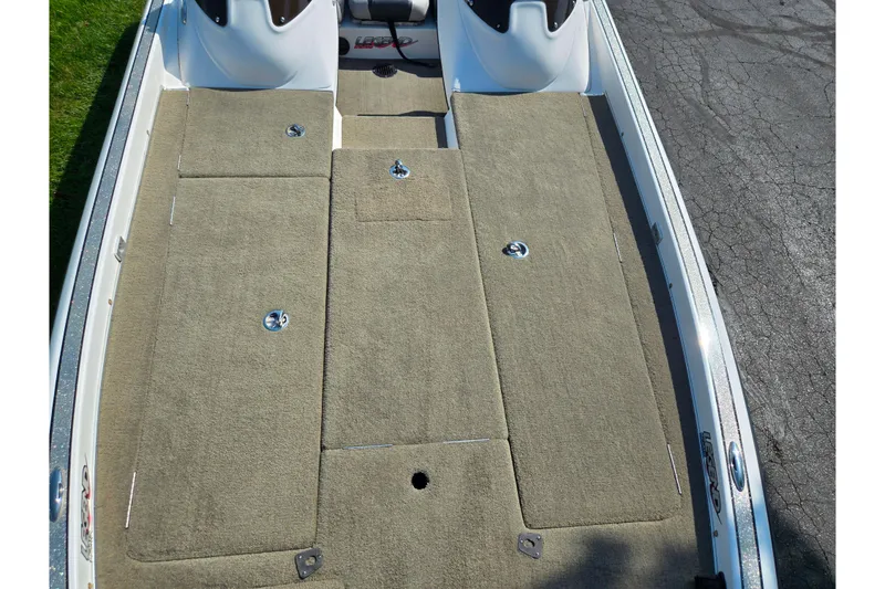Slide: The Image of 2016 Legend Alpha 211R DC boat deck with carpeted storage compartments. - 18