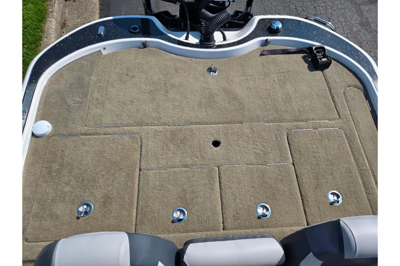 Slide: The Image of 2016 Legend Alpha 211R DC boat deck with carpeted surface and storage compartments. - 21