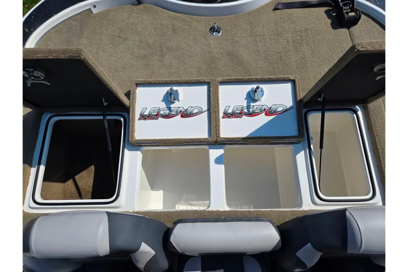 Slide: The Image of 2016 Legend Alpha 211R DC boat interior with open storage compartments. - 22