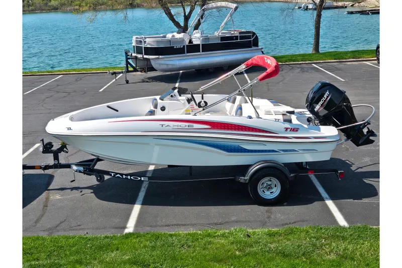 The Image of 2024 Tahoe T16 boat on trailer by a lake, featuring sleek design and vibrant colors. - 0