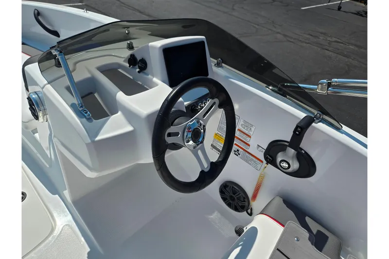 Slide: The Image of 2024 Tahoe T16 boat dashboard with steering wheel and control panel. - 11
