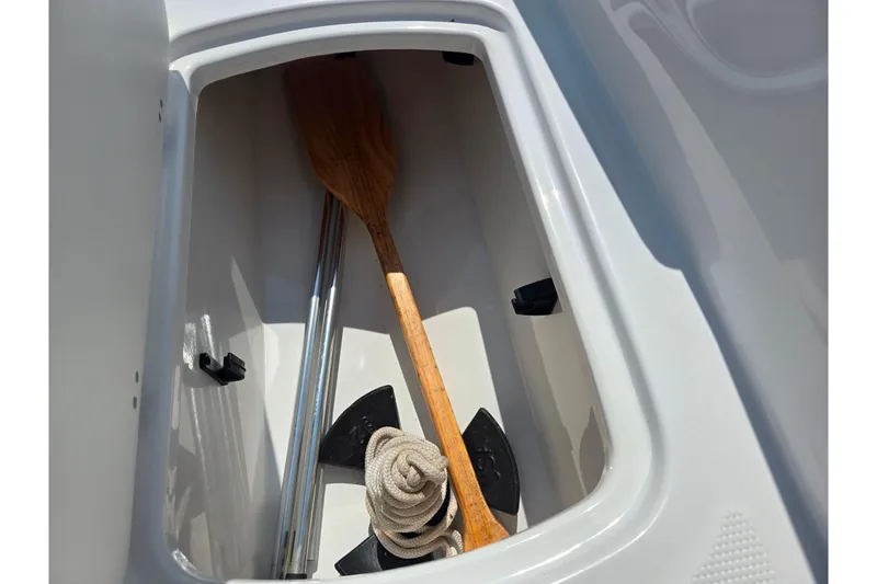 Slide: The Image of Storage compartment of 2024 Tahoe T16 boat with paddle, anchor, and rope. - 15