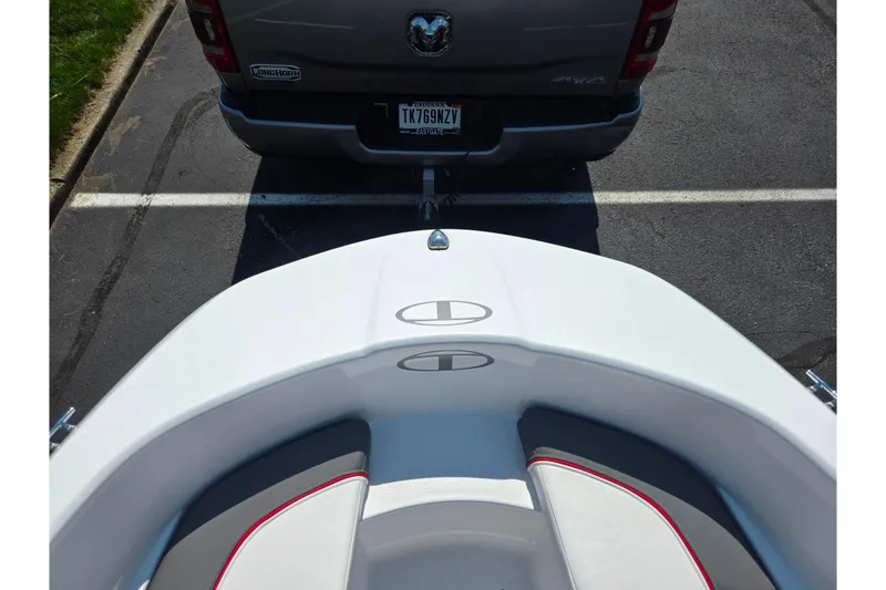 Slide: The Image of 2024 Tahoe T16 boat hitched to a truck in a parking lot. - 17