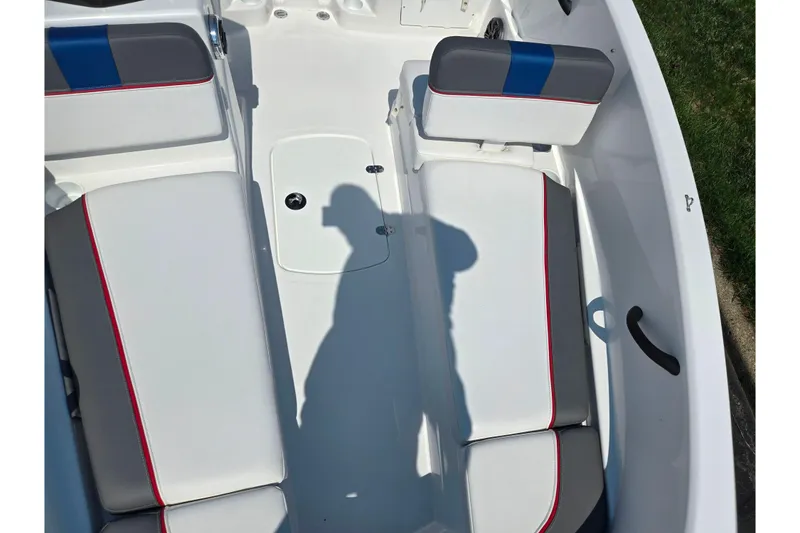 Slide: The Image of 2024 Tahoe T16 boat interior with white and gray seating, red accents, and shadow. - 18