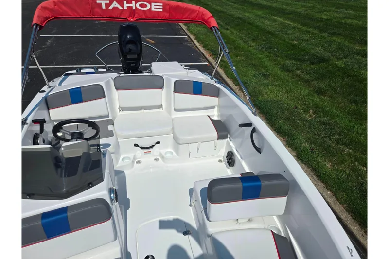 Slide: The Image of 2024 Tahoe T16 boat interior with seating, steering wheel, and red canopy. - 19