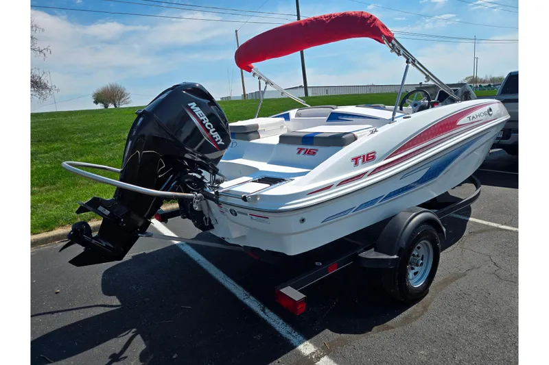 Slide: The Image of 2024 Tahoe T16 boat with Mercury engine on trailer, parked outdoors. - 3