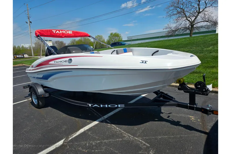Slide: The Image of 2024 Tahoe T16 boat with red canopy on trailer in parking lot. - 5