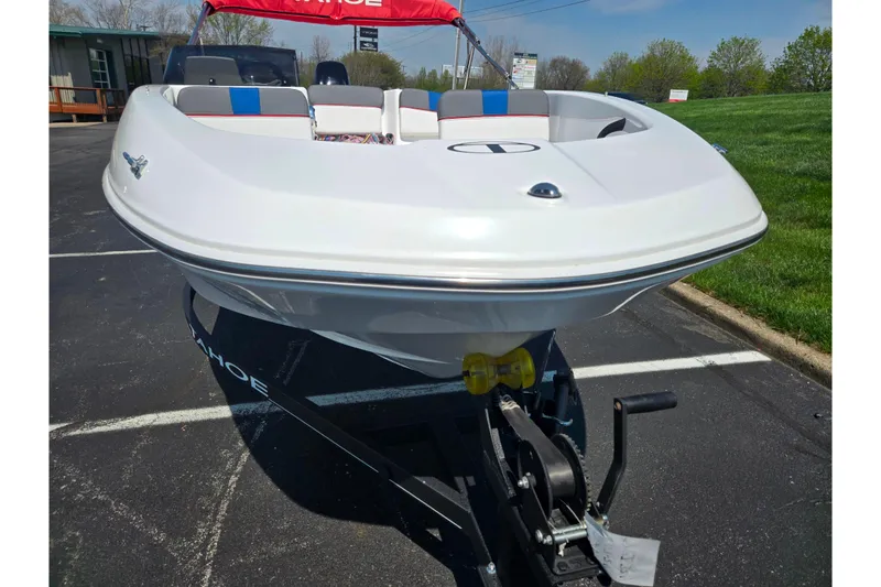 Slide: The Image of 2024 Tahoe T16 boat on trailer, white hull, parked outdoors. - 6