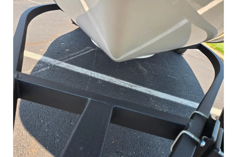 Slide: The Image of 2024 Tahoe T16 boat on trailer, parked on asphalt with visible white lines. - 7