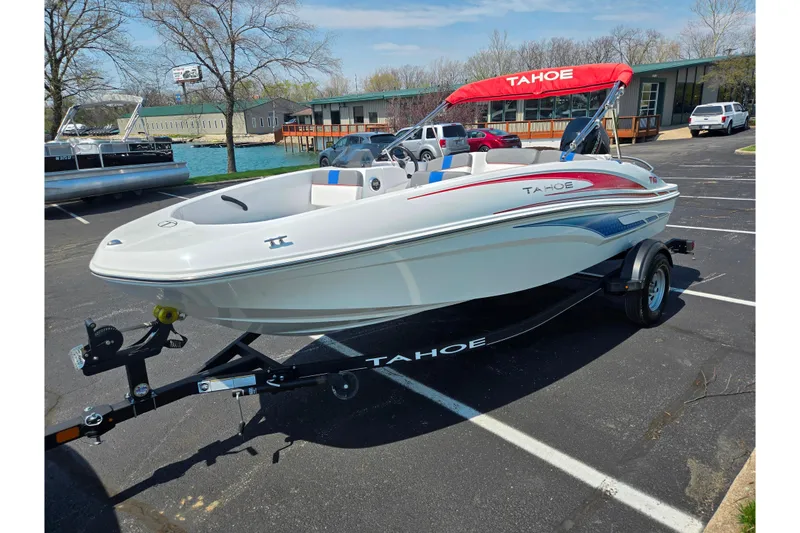 Slide: The Image of 2024 Tahoe T16 boat with red canopy on trailer in parking lot. - 8