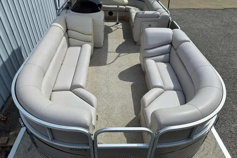 Slide: The Image of 2007 South Bay 8522 CR E series pontoon boat with spacious seating and beige upholstery. - 1