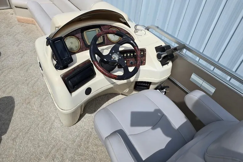Slide: The Image of 2007 South Bay 8522 CR E series boat dashboard with steering wheel and controls. - 2