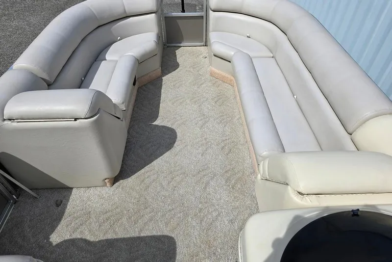 Slide: The Image of 2007 South Bay 8522 CR E series pontoon boat interior with beige seating and carpet. - 3