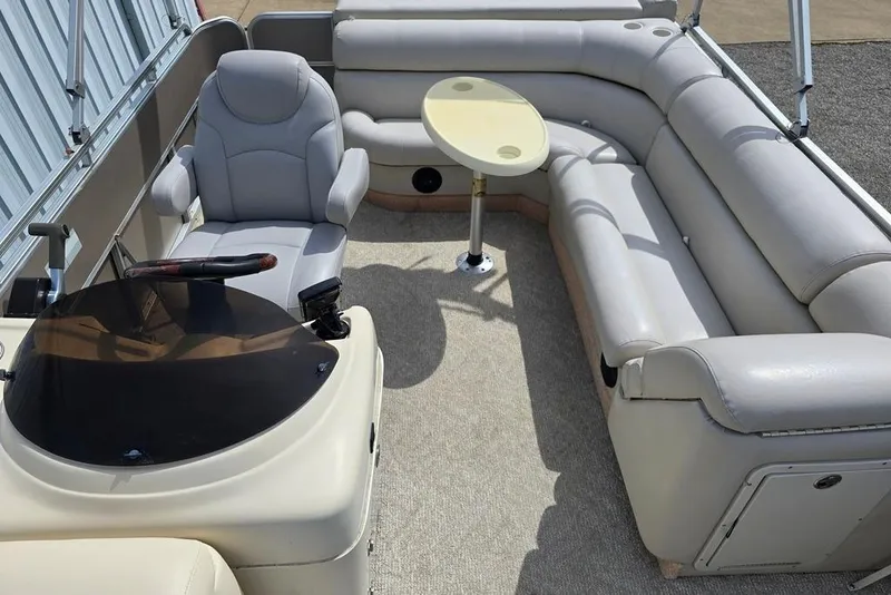 Slide: The Image of 2007 South Bay 8522 CR E series pontoon boat interior with seating and steering console. - 4
