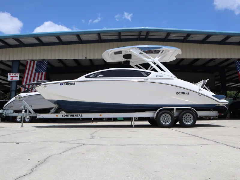 Slide: The Image of 2020 Yamaha Boats 275SD on trailer in front of warehouse. - 2