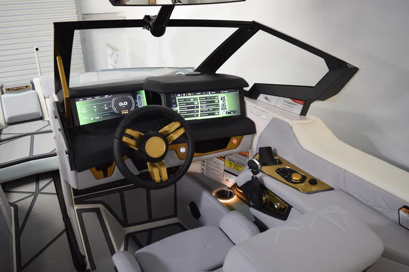 Slide: The Image of 2026 Nautique Super Air Nautique G25 Paragon cockpit with advanced digital controls and luxurious seating. - 13