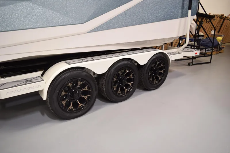Slide: The Image of 2026 Nautique Super Air Nautique G25 Paragon trailer with triple black alloy wheels. - 30