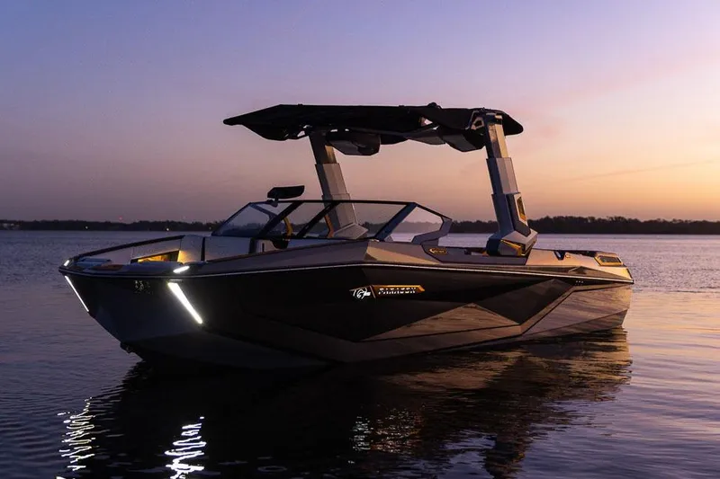 Slide: The Image of Manufacturer Provided Image: 2026 Nautique Super Air Nautique G25 Paragon boat at sunset on calm water. - 34