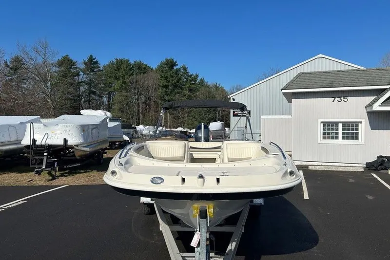 The Image of 2009 SouthWind 210 SD boat on trailer, parked near a building and trees. - 1
