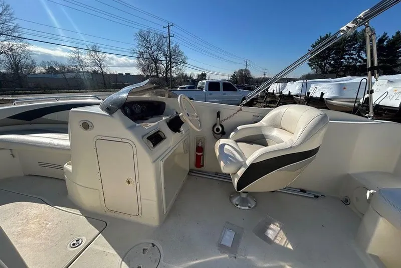Slide: The Image of 2009 SouthWind 210 SD boat interior with captain's chair and steering console. - 12