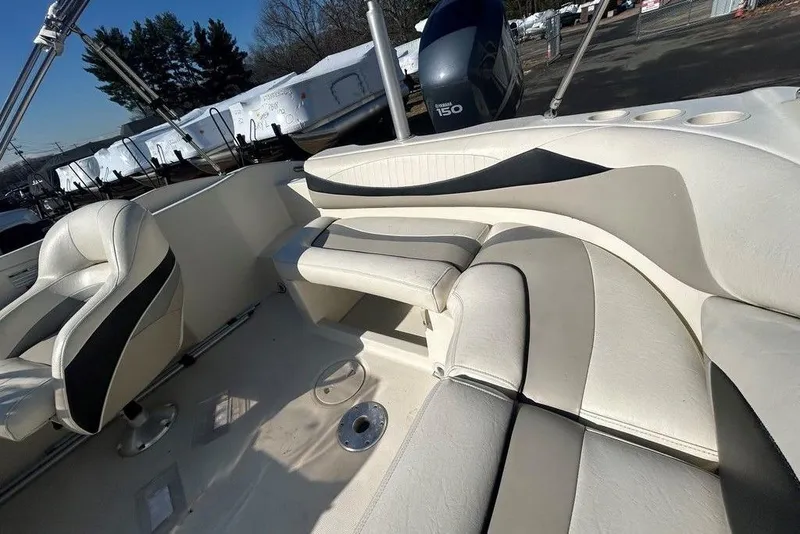 Slide: The Image of Interior of a 2009 SouthWind 210 SD boat with white and gray seating. - 13