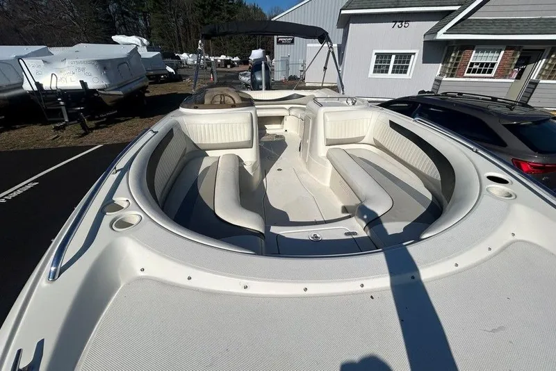 Slide: The Image of 2009 SouthWind 210 SD boat with spacious seating, parked outdoors near buildings. - 19
