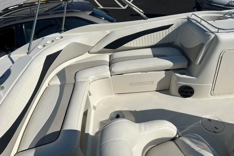 Slide: The Image of Interior of a 2009 SouthWind 210 SD boat with white seating and storage compartments. - 3